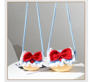 Close-up of handmade crochet princess bags in two sizes with red bow details