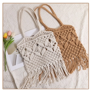 Close-up detail of bohemian handmade cotton macrame weaving patterns and long fringes