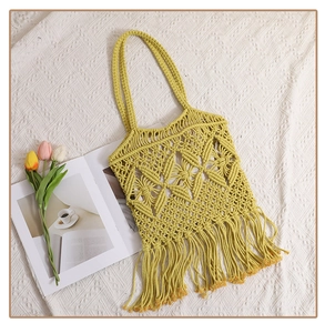 Detailed view of yellow macrame woven tote bag with fringe and hollow geometric pattern