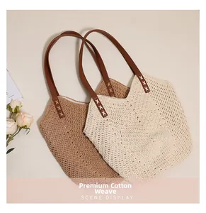 Detail of premium cotton thread woven tote bags with leather straps and X-stitch accents