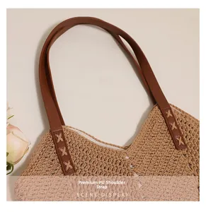 Detail of high-quality PU shoulder straps on large capacity woven tote bag for beach