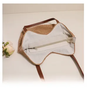 Detailed view of woven shoulder bag featuring a smooth zipper and cream fabric lining