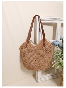 Macro detail of handwoven cotton rope texture and brown leather handle on beach tote bag