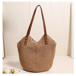 Detail of herringbone weave texture and brown leather strap on a handmade beach bag
