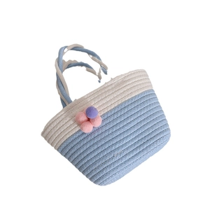 Blue and white woven cotton tote bag with colorful pom-pom flower decorations