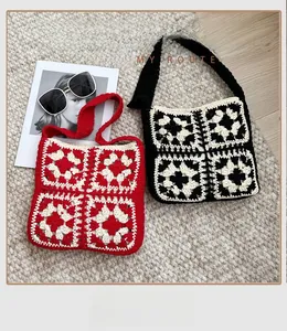 Detail of red and black crochet granny square shoulder bags with woven shoulder straps