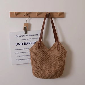 Handwoven khaki cotton thread shoulder bag with brown leather handles for beach vacation