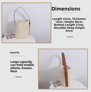 Detail of woven straw bucket bag with adjustable leather strap and drawstring lining