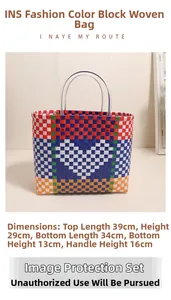 Close-up of a large capacity woven plastic tote bag with colorful heart pattern detail