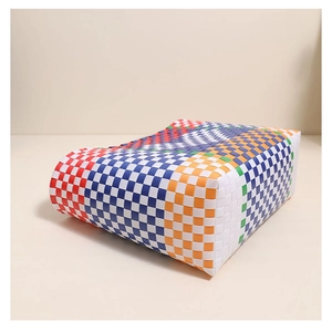 Detail showing the colorful woven plastic basket with vibrant checkered pattern texture