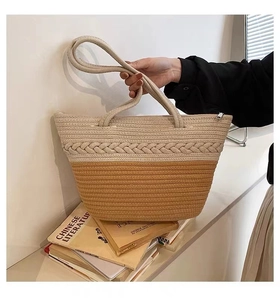 Detail of large woven tote bag with contrast stitching and sturdy circular handles