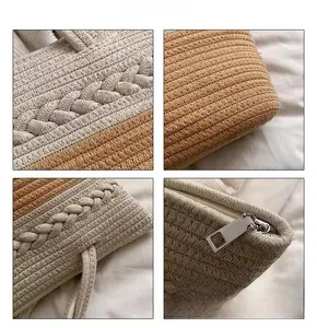 Close-up showing the woven texture, two-tone stitching and zipper of the straw beach bag