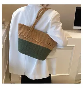 Shoulder view of large woven cotton tote bag in khaki and dark green color block