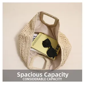 Close-up of beige woven straw handbag showing spacious interior with sunglasses and magazine