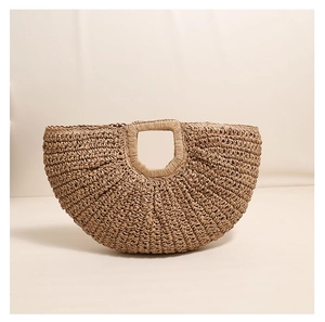Detailed weave pattern and round hollow handle of the straw crescent handbag