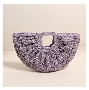 Close-up of light purple semi-circular woven straw handbag with a square handle cut-out