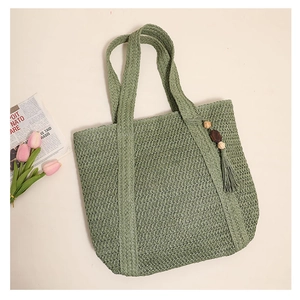 Detail of sage green woven tote bag with wood bead tassel and tulip decoration