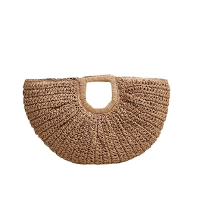 Minimalist crescent straw woven handbag with round handle for beach vacations