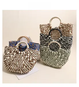 Detail of half-round woven straw bags showcasing five different color combinations