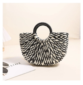 Detailed macro view of a half-moon woven straw handbag with black and white stripes