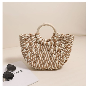 Close-up of dual-tone straw weaving pattern on a semi-circle vacation handbag