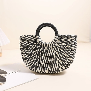Handmade black and white woven half-moon straw handbag with elegant circular top handles
