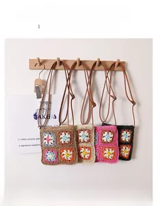 Detail of four crochet crossbody bags in various colors featuring retro hollow flower patterns