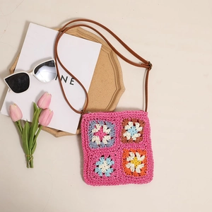 Floral crochet crossbody straw bag with colorful square patterns and leather strap