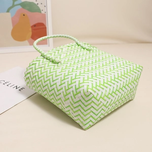 Cute green and white woven plastic handbag in a minimalist square tote beach bag style
