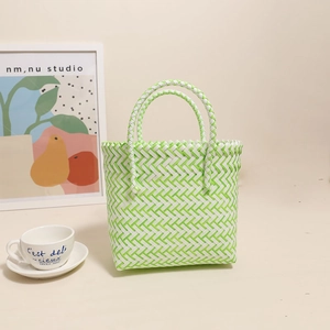 Green and white woven plastic tote bag for beach vacations and daily grocery use