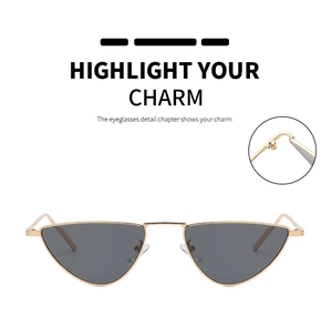 Close-up of golden metal hinge and sleek triangular frame of retro cat eye sunglasses