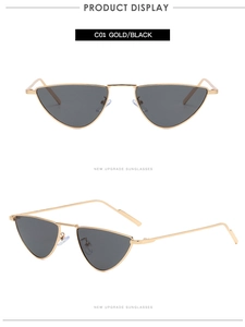 Detail view of gold metal triangular cat-eye sunglasses with black lenses and slim frames