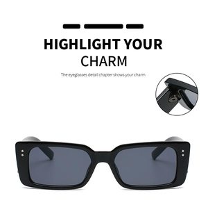 Detail view of reinforced metal hinge and silver rivets on black rectangular sunglasses