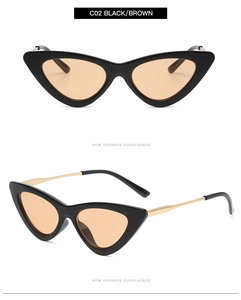 Detail view of vintage cat-eye sunglasses with black frames and gold metal temples
