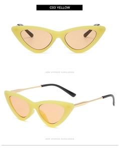 Detail view of yellow cat eye sunglasses with orange lenses and gold metal temples