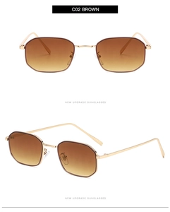 Close-up of retro hexagonal sunglasses with gold metal frames and brown gradient lenses
