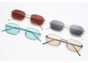 Flat lay of retro octagonal metal sunglasses in dark red, green, grey, and orange colors