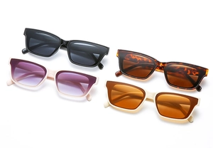 Flat lay of square sunglasses in black, tortoiseshell, cream and white frames