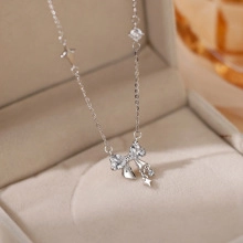 Detailed macro view of S925 silver bowknot necklace with zircon stars in a jewelry box