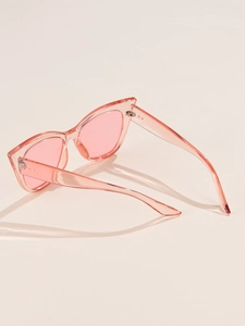 Close-up of pink cat eye sunglasses with transparent resin frames and metal hinges