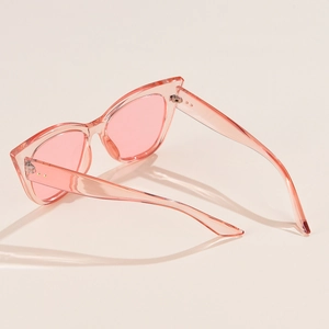 Pink transparent cat-eye sunglasses with metal rivets and stylish tinted lenses
