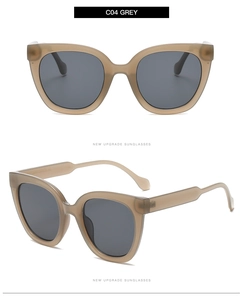 Detail of oversized sunglasses with translucent beige frames and dark grey lenses