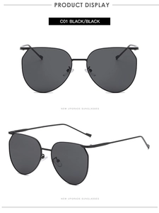 Detailed macro view of minimalist black oval sunglasses with slim metal frames