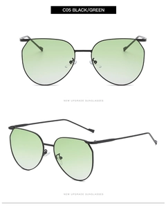 Detail view of oval metal sunglasses with black frames and green gradient lenses