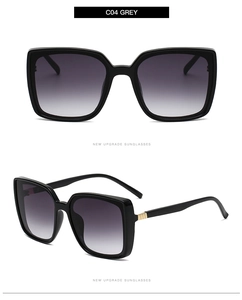 Detailed view of oversized square sunglasses with gold accents and grey gradient lenses