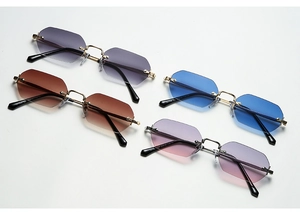 Detailed display of four rimless octagonal sunglasses with various gradient colored lenses