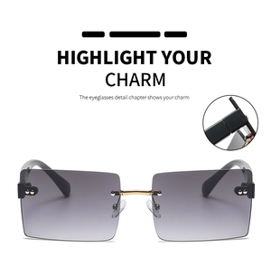 Detail of metal hinge and gradient grey lenses on rimless rectangular sunglasses
