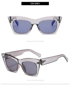 Detail of transparent grey cat eye sunglasses featuring wide temples and metallic hinges