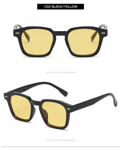 Detail view of black irregular frames with yellow lenses and silver metal hinges