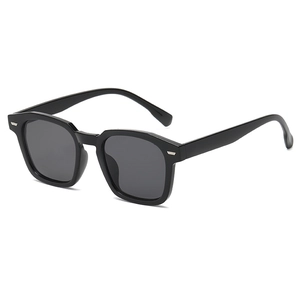 Classic black irregular polygon sunglasses with silver rivets shown from a 45-degree angle